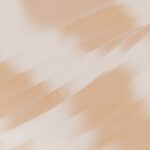 A blurry photo of a person holding a cell phone